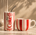 Diet Coke ceramic tumbler and stripe mug set on marble surface