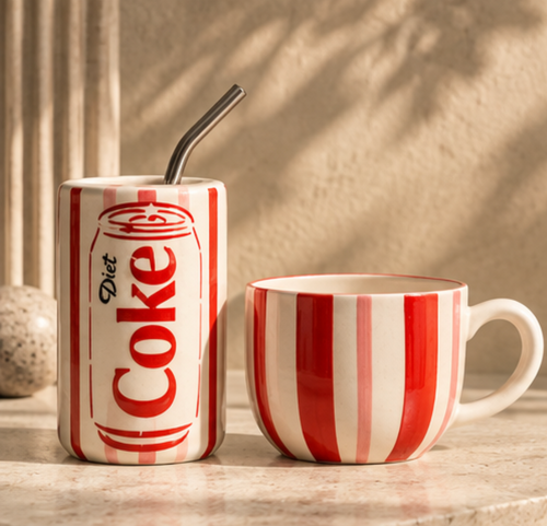 Diet Coke ceramic tumbler and stripe mug set on marble surface