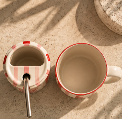 Top view of Diet Coke tumbler and mug showing straw opening and interior