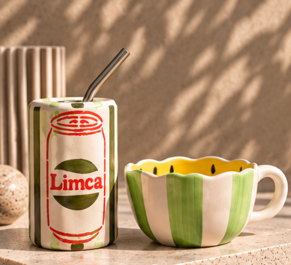 Limca ceramic tumbler and lemon mug set on marble surface